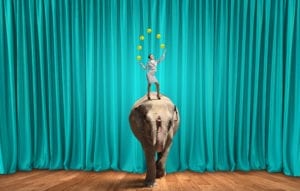 Improve Dental Front Office Efficiency With Some Training. A Young Businesswoman stands on an elephant juggling balls. 