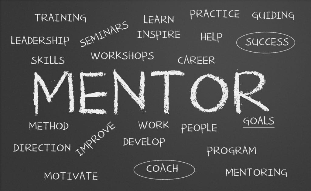 Front Desk Dental Office Training Is Better With A Mentor. The Word Mentor Is Written On A BlackBoard