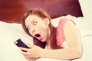 Dental Hygiene No Show Policy explained by a woman waking up in her bed to an alert on her cell phone.