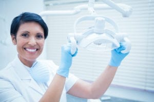 An online course to assist the dental front office reach their dental office production goals. A female dentist is smiling because her dental office production goals have been reached.