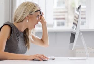 Mistakes in dental claims result in denials. A dental front office team member looks at her computer screen in shock at her error.