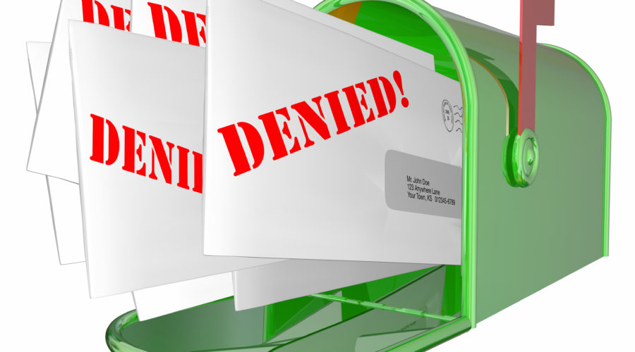 A mailbox holds envelopes with "denied" stamped on them. The dental office wants to avoid denied dental claims.