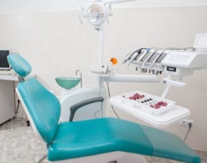An empty dental chair represents new patients not converting from their new patient call to a scheduled appointment. 
