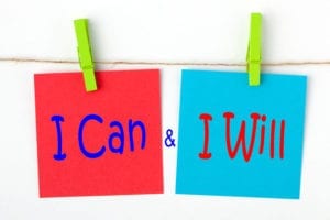The words "I can" and "I will" on color post it notes represent the motivation to run dental office weekly reports.