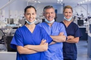 Dental office assistants and dentists too are part of a good team huddle.
